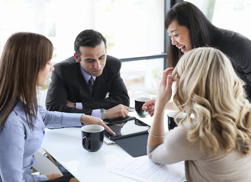 Business Professionals Reading Case Studies on a Tablet