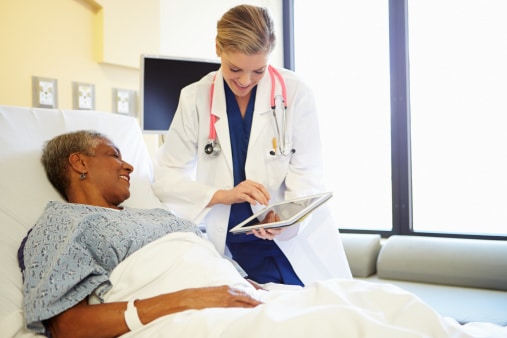 Doctor showing patient charts using a medical grade tablet pc