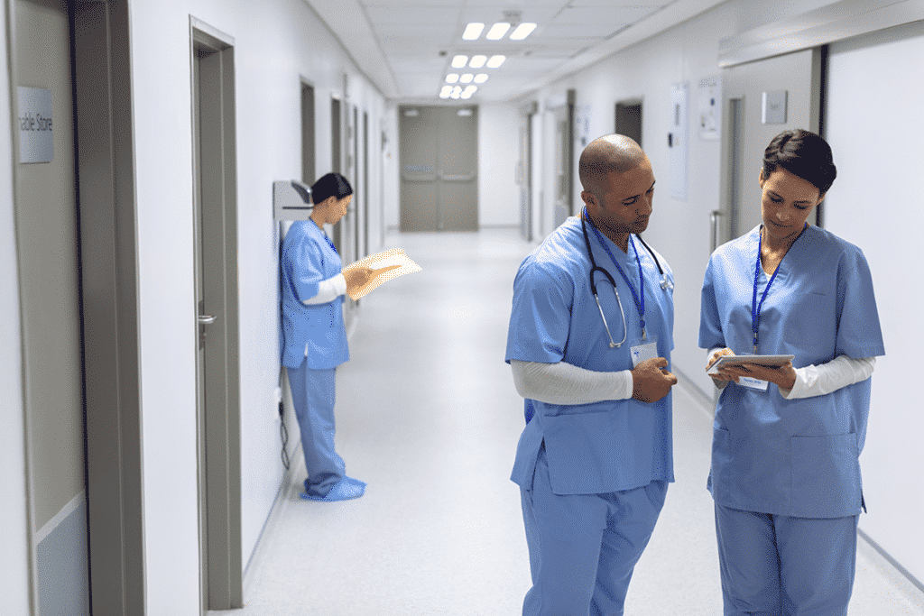 Nurses reviewing the location of patients and status on a tablet